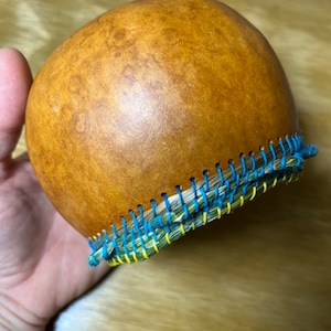 Sweetgrass-rimmed gourd basket