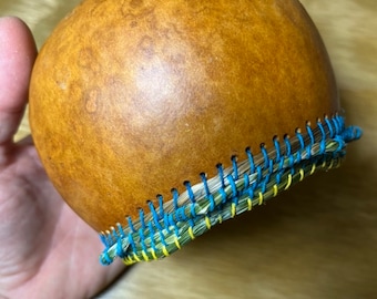 Sweetgrass-rimmed gourd basket