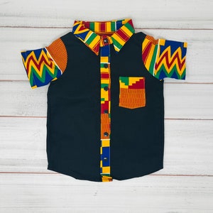 May include: A black short-sleeved button-down shirt with a colorful patterned collar and cuffs. The pattern features red, yellow, green, and blue colors.