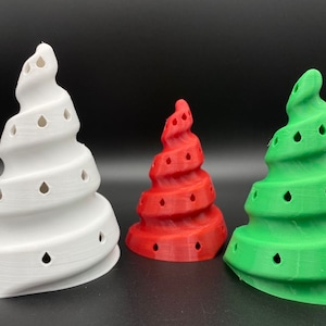 May include: Three spiral-shaped Christmas tree ornaments in white, red, and green. Each ornament has a series of small holes in the shape of teardrops.