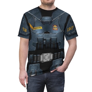 May include: A black t-shirt with a blue and gray printed design of a futuristic soldier's armor. The design includes a belt, pouches, and a chest plate with the text "MORRISON" and "ZAP" printed on it.