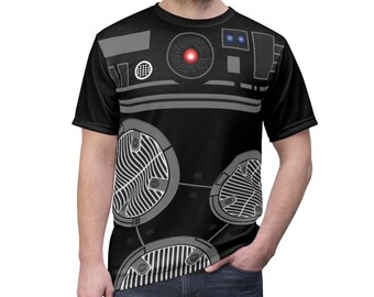 May include: Black t-shirt with a graphic print of a robot with a red eye and gray details.
