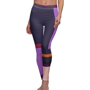 May include: Purple, black, and orange patterned leggings with a geometric design. The leggings are made of a stretchy, comfortable fabric.