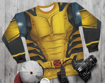 May include: Yellow and black sweatshirt with a superhero design. The sweatshirt has a zipper and a hood.