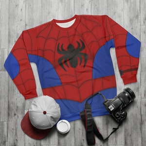 May include: Red and blue sweatshirt with a spider web design and a black spider in the centre. The sweatshirt has long sleeves and a crew neck.