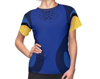 May include: A blue, yellow, and black short-sleeved t-shirt with a geometric pattern. The shirt has a crew neck and a relaxed fit.