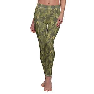 May include: Camouflage leggings with a green and brown pattern. The leggings are fitted and have a high waist.