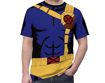 May include: A blue, black and yellow t-shirt with a superhero costume design. The design features a red X on the chest and a yellow belt with a red X.