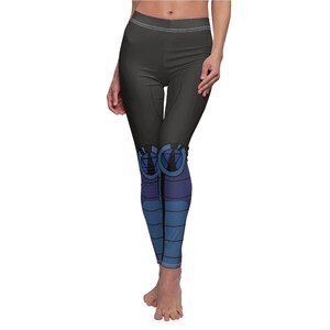 May include: Black leggings with a blue and purple design on the lower legs. The design features a geometric pattern and a circle with a triangle inside.