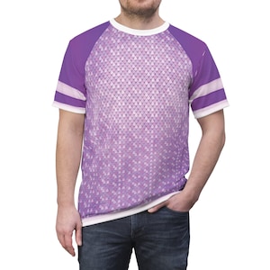 May include: A purple and white short-sleeved t-shirt with a white collar and a pattern of small white teardrop shapes on the front. The sleeves have a white stripe.
