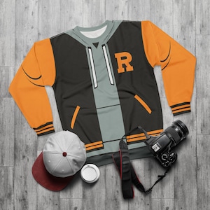 May include: A black and orange hooded sweatshirt with a varsity jacket design. The sweatshirt has a large letter "R" on the front and a white zipper.