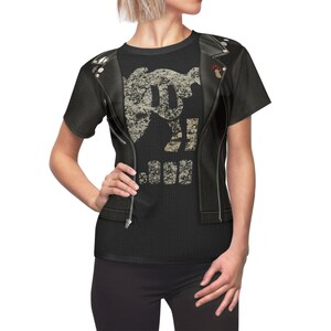 May include: Black t-shirt with a graphic of a skull wearing a leather jacket and the word "JUNK" printed below. The t-shirt has a faux leather jacket design printed on the front.