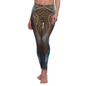 May include: High-waisted leggings with a unique design. The leggings feature a brown, rope-like pattern in the center, with blue accents and a speckled design on the sides. The leggings are form-fitting and made of a stretchy material.