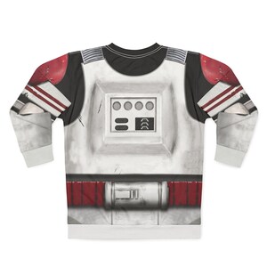 May include: White and black long-sleeved top featuring a graphic design of a space trooper's armour. The design includes red accents on the shoulders and waist, with a detailed chest plate featuring circular and rectangular elements.
