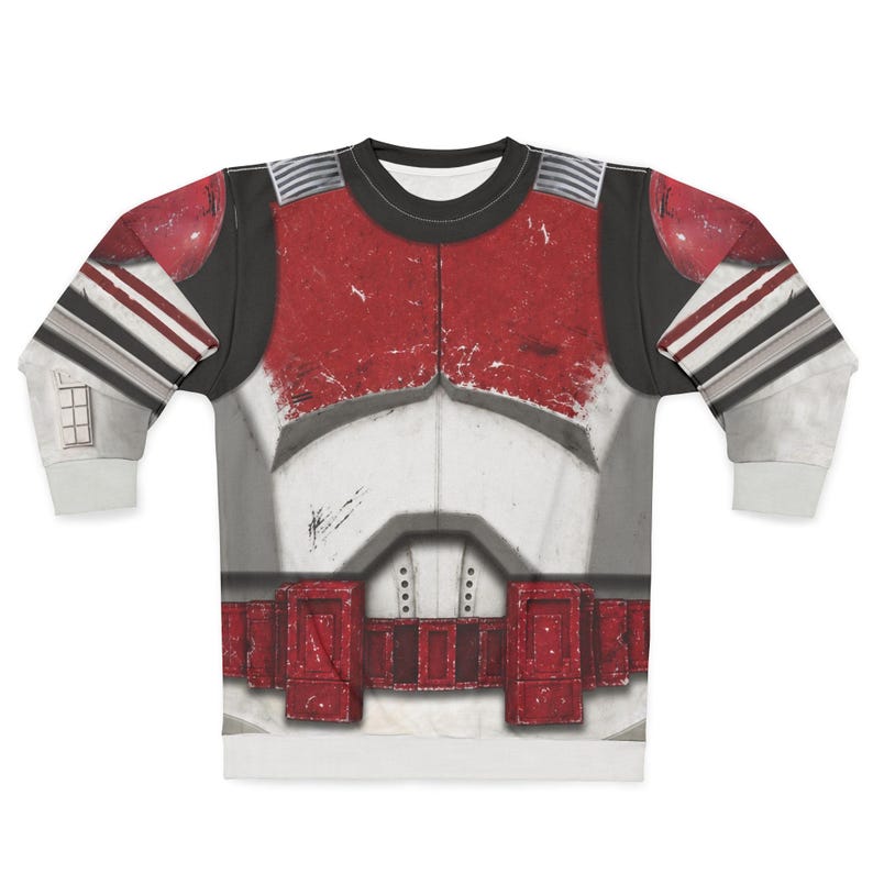 May include: A long-sleeved sweatshirt with a detailed print of a red, white, and grey battle suit. The design includes a chest plate, shoulder pads, and a belt, with distressed textures for a realistic look. The sleeves have grey and white stripes.
