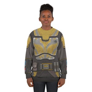 May include: A grey and yellow sweatshirt with a detailed armour design. The design incorporates yellow and silver panels, pockets, and a belt buckle. The sleeves are grey, and the overall style suggests a futuristic or sci-fi theme.