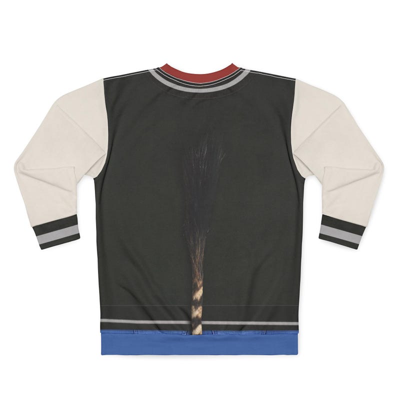 May include: A black sweatshirt with cream-colored sleeves. The sleeves have a black and gray stripe at the wrist. The neckline has a red and gray stripe. The front of the sweatshirt has a dark image of a plant.