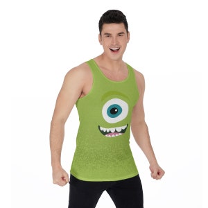 May include: A green tank top featuring a cartoon monster face print on the front. The monster has one large blue eye and a wide, toothy grin.