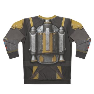May include: A long-sleeved sweatshirt with a detailed print of a jetpack and armour design. The design incorporates shades of grey, gold, and silver, with a black background. The sleeves have additional armour details and accents of red and blue.
