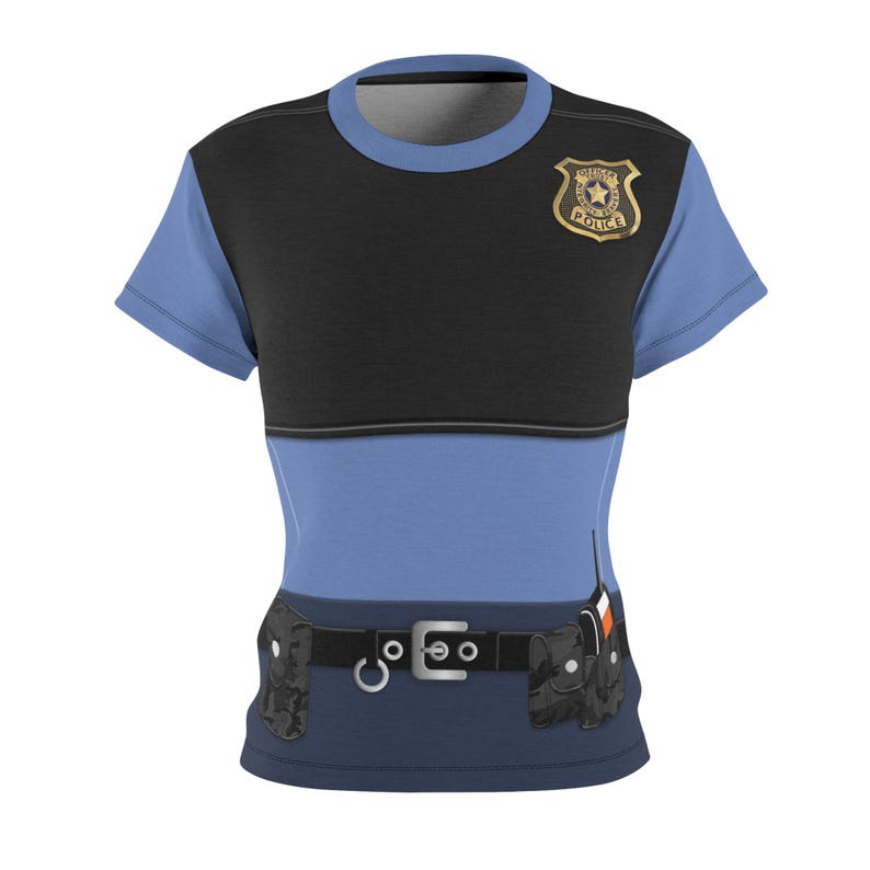 May include: A blue and black t-shirt designed to resemble a police uniform. The shirt features a gold-colored badge, a black belt with a silver buckle, and two black pouches. The design includes a light blue short-sleeved shirt.