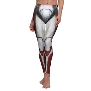 May include: White leggings with a printed design featuring gray, black, and red accents. The leggings have a detailed pattern resembling a futuristic or sci-fi aesthetic. The design covers the entire length of the leggings, creating a cohesive look.