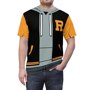 May include: A black and orange short-sleeved t-shirt with a graphic of a black and grey hoodie with a white zipper and a black letter 'R' on the front.