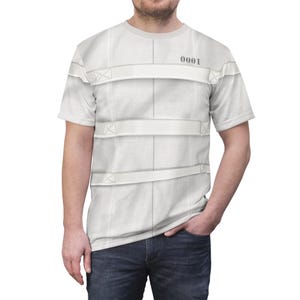 May include: White t-shirt with a printed design of white straps and the number "0001" on the front.