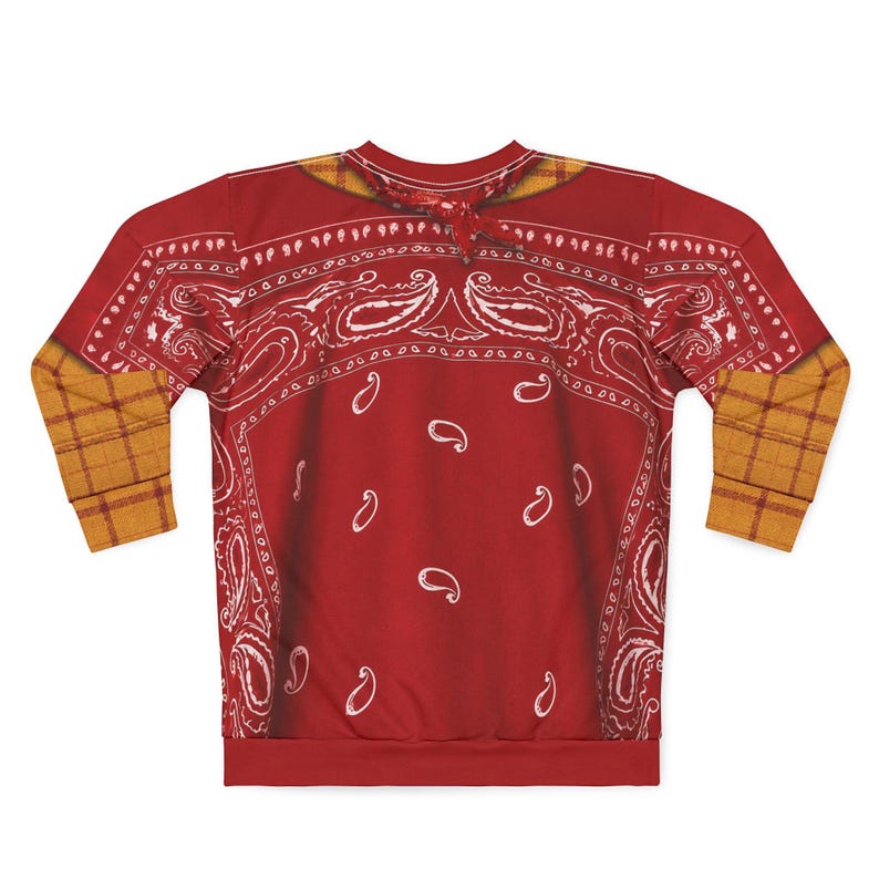 May include: A long-sleeve sweatshirt featuring a red bandana print with white paisley patterns across the chest and back. The garment includes a yellow and brown plaid pattern on the sleeves and a matching plaid collar detail at the neckline.