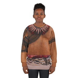 May include: A long-sleeve crewneck sweatshirt featuring a printed design of a tan skin-toned torso with a dark tribal-style necklace graphic, black geometric arm patterns, and a patterned fabric detail along the bottom hem in shades of brown and red.
