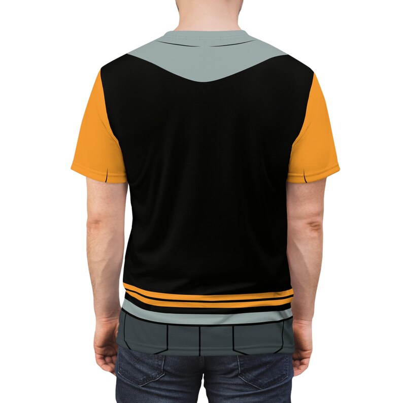 May include: A black t-shirt with a grey and orange design. The shirt has a grey collar and a grey stripe across the chest. The orange design is on the sleeves and the bottom of the shirt.