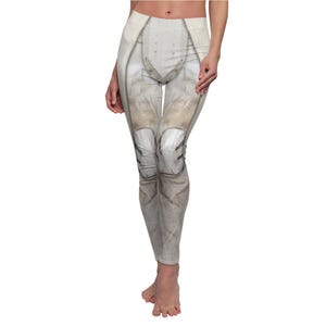 May include: Full-length leggings with a digitally printed design resembling a futuristic armored suit. The leggings feature a light beige and gray color scheme with details mimicking knee pads and other protective elements.