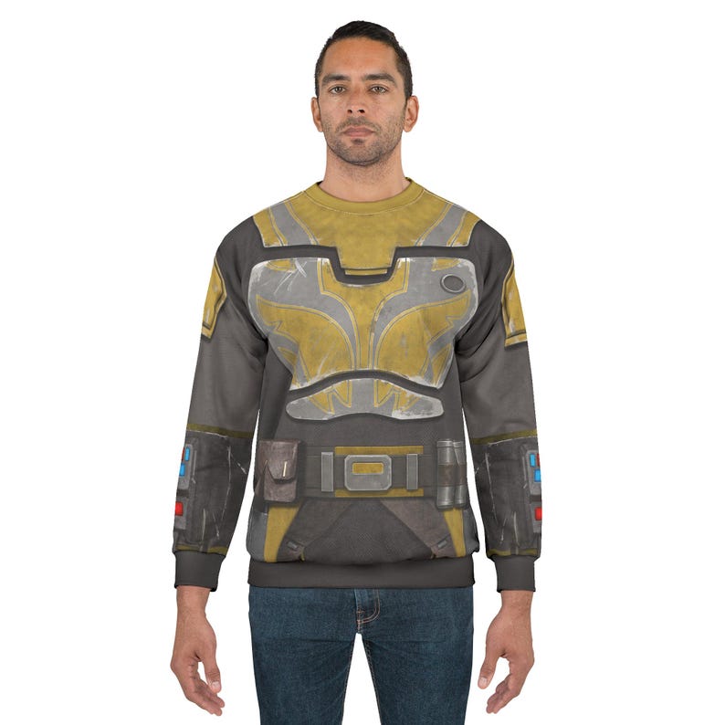 May include: A grey and yellow sweatshirt with a detailed armour-like design. The design includes a yellow chest plate, grey accents, and a belt with a buckle. The sleeves have additional details, and the overall look is reminiscent of a futuristic or sci-fi theme.