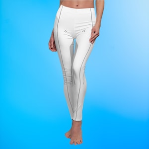 May include: White leggings with black accent lines. The leggings have a high waist and a form-fitting design. The black lines run along the sides and front of the leggings, creating a streamlined look. The background is a gradient of blue.