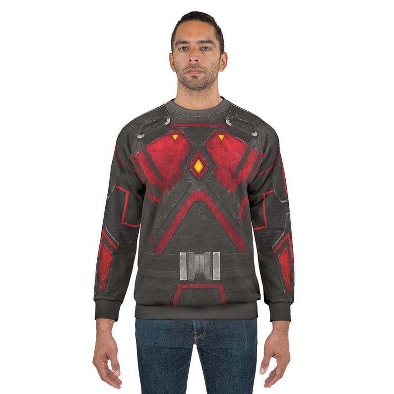 May include: A gray sweatshirt with a red and black design resembling armor. The design includes geometric shapes, lines, and a belt-like detail across the midsection. The sweatshirt has long sleeves and a crew neck.