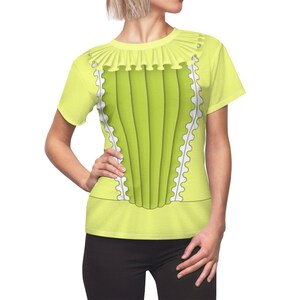 May include: A yellow short-sleeved t-shirt with a green and white design that resembles a corset. The shirt has a ruffled collar.