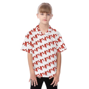 May include: White button-down shirt with a repeating pattern of red figures holding hands. The short-sleeved shirt is worn by a person. The shirt has a collared neckline and is made of a lightweight fabric.