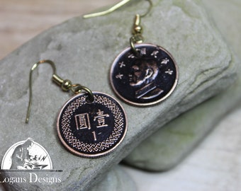 May include: A pair of earrings made from Chinese 1 Yuan coins. The coins are copper colored and feature a portrait of a man on one side and Chinese characters on the other. The earrings are attached to gold-colored hooks.