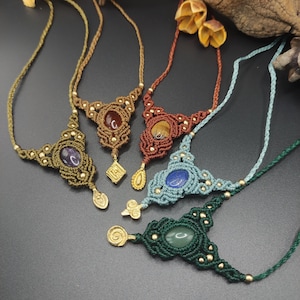 May include: Five macrame necklaces with different coloured stones and gold accents. The stones are amethyst, tiger's eye, carnelian, lapis lazuli, and aventurine.