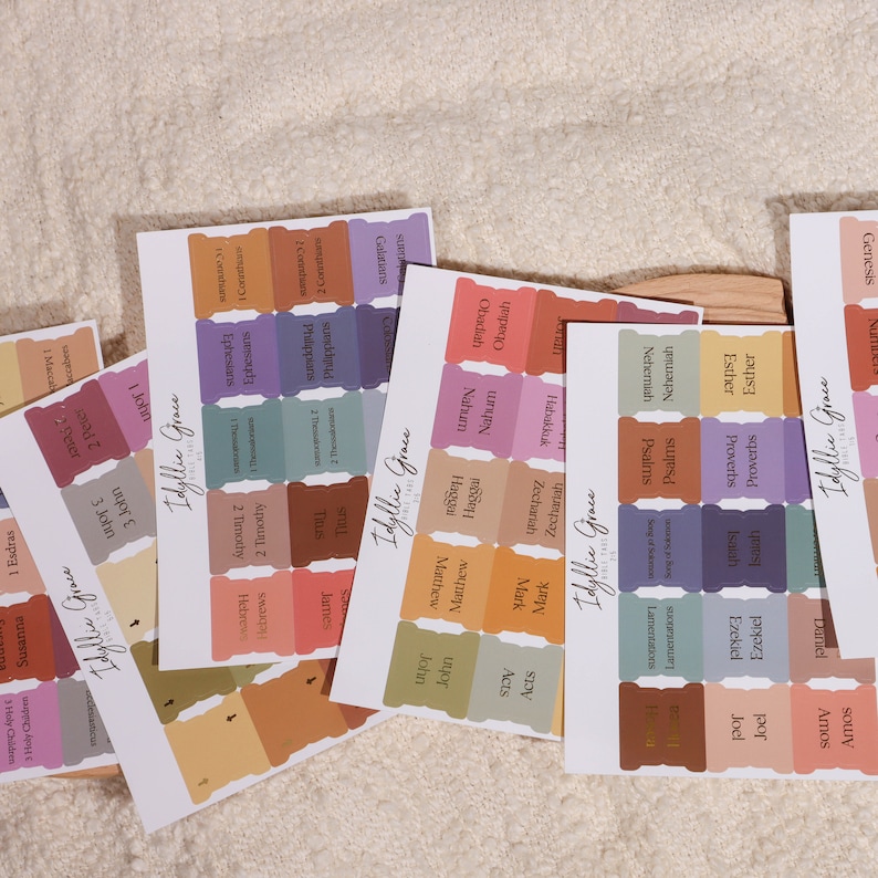 May include: A set of colorful Bible verse stickers with different book titles and chapter numbers. The stickers are designed with a scalloped edge and have a vintage aesthetic.