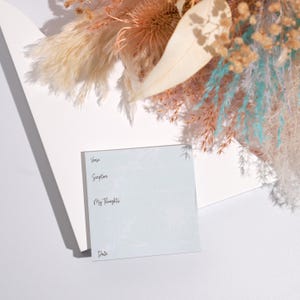 May include: A white card with a light blue background and a delicate floral pattern. The card has the words "Verse", "Scripture", "My Thoughts", and "Date" written on it.