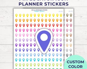 May include: A sheet of colorful planner stickers featuring a pin locator icon. The stickers are arranged in a rainbow pattern, with each row featuring a different color. The stickers are labeled "AN 35" and "CUSTOM COLOR OPTION".