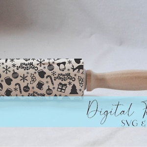 May include: A wooden rolling pin with a patterned surface featuring black Christmas-themed icons like snowflakes, ornaments, and reindeer on a beige background. The text "Merry Christmas" is also visible. The handle is light brown. The words "Digital File SVG & DXF" are written in cursive.
