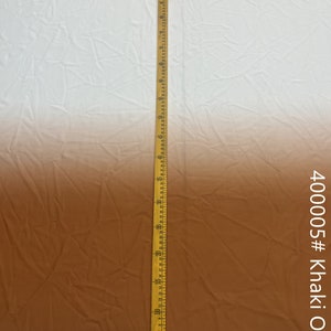 May include: A close-up of a fabric swatch with a gradient from white to brown. A ruler is placed next to the fabric, showing the fabric is 40 inches long. The fabric is labeled "400005 # Khaki Ombre".