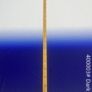 May include: A white to dark blue ombre fabric with a wooden ruler measuring 96 inches. The fabric is smooth and has a slight sheen. The fabric is labeled "400003# Dark Blue".