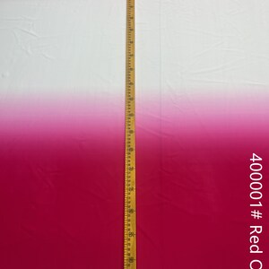May include: A white and red ombre fabric with a wooden ruler measuring 96 inches. The fabric is smooth and has a slight sheen. The fabric is labeled "40001 # Red Ombre".