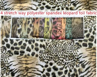 May include: A 4 stretch way polyester spandex leopard foil fabric with a white background and black spots. A rectangular swatch card displays thirteen vertical strips of the fabric in various colors including brown, yellow, pink, orange, and teal.