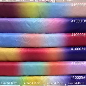 Puede incluir: Rollos de tela spandex con degradado de colores, incluyendo amarillo, azul, rosa y rojo. Cada rollo está numerado y mide aproximadamente entre 35 cm y 40 cm de ancho.
