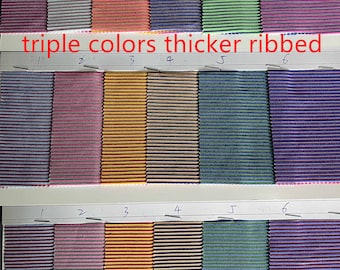 May include: A sample card with six different fabric swatches. Each swatch is a different color and has a ribbed texture. The card is labeled "triple colors thicker ribbed".
