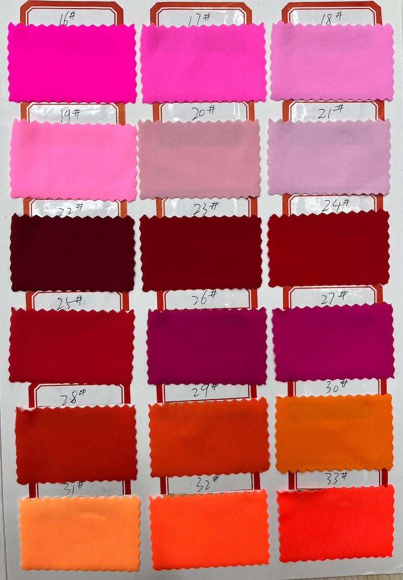 May include: A color swatch chart featuring eighteen rectangular fabric samples with pinked edges, arranged in six rows and three columns. Each sample is labeled with a number from 16# to 33#, displaying a spectrum of pink, red, and orange shades.