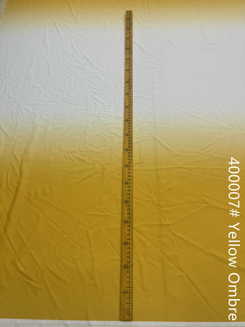May include: A yellow ombre fabric with a white top. A ruler is placed next to the fabric to show the length. The fabric is labeled "400007# Yellow Ombre".